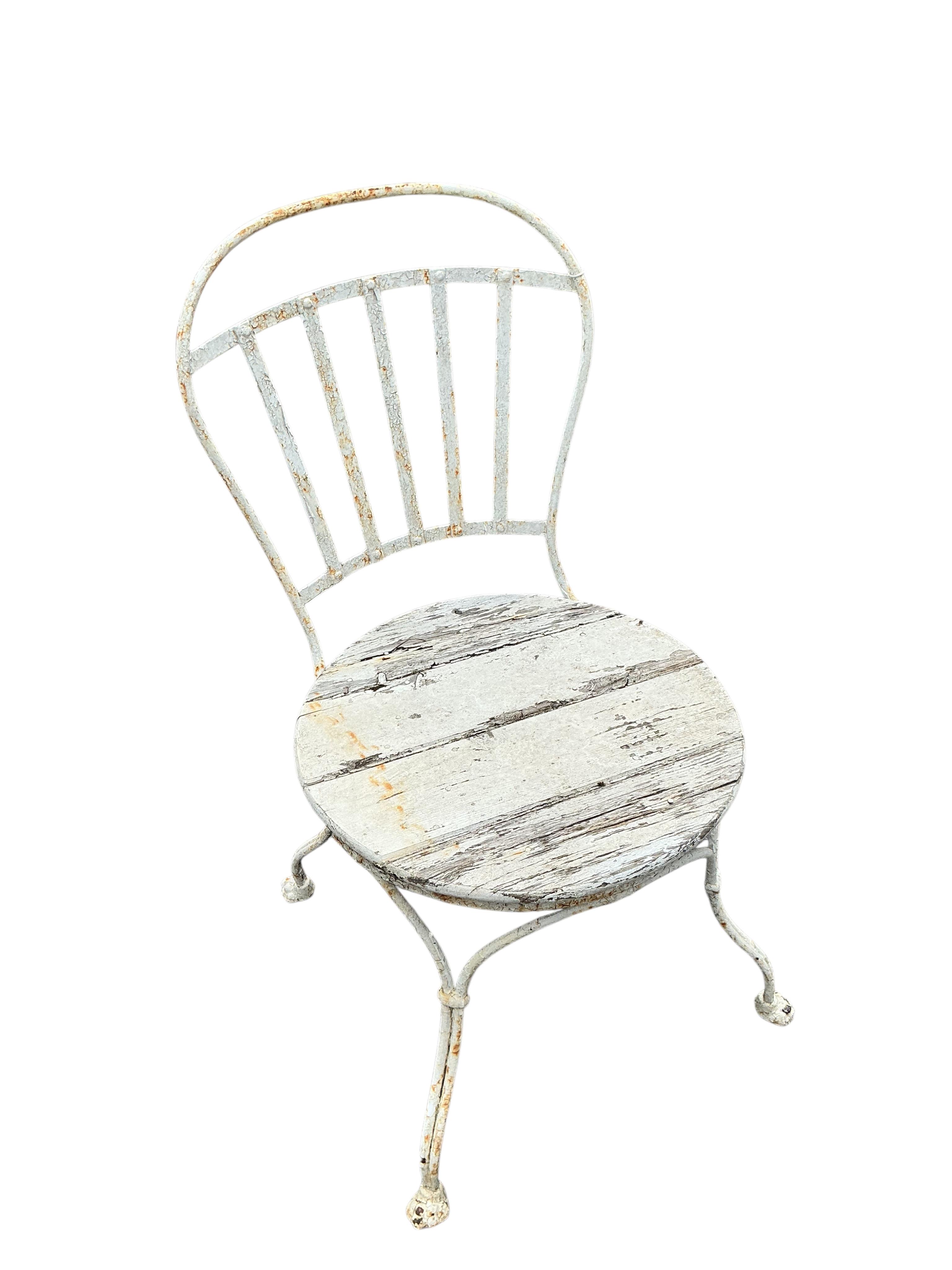 A Victorian Coalbrookdale style later painted circular cast iron garden table, diameter 61cm, height 70cm together with two later chairs
